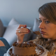 Titled in the stock image library as “Depressed Woman Eats Cake”
